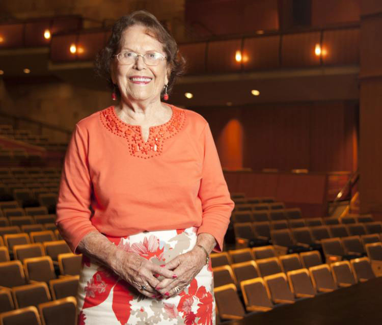 Barbara K. Jackson stands amid the seats of Jackson Hall.