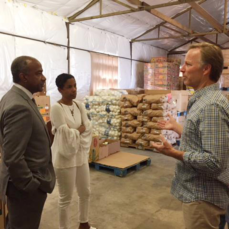 Chancellor Gary S. May and LeShelle May with Yolo Food Bank Executive Director Michael Bisch.