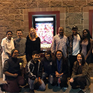 Chancellor Gary S. May and others pose in front of movie theater.