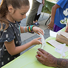 Girl at UC Davis Young Scientist Program table