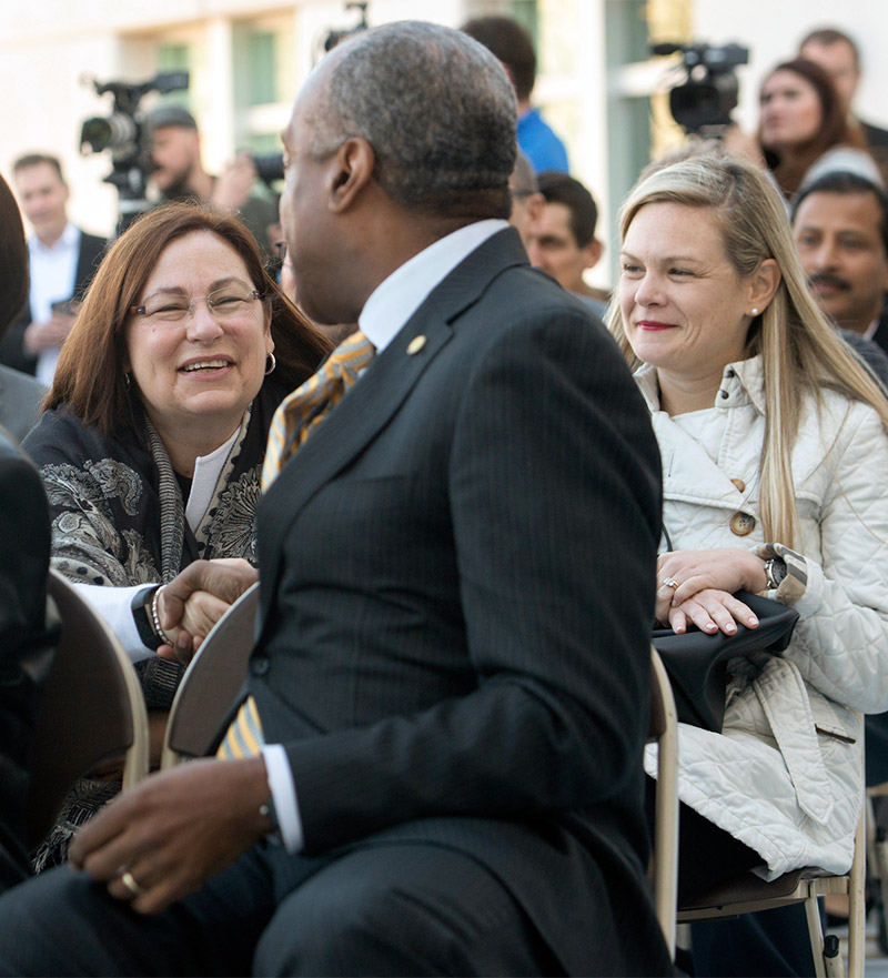 Chancellor Gary S. May shakes hands with Kim Hewitt of IBM.