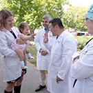 Doctors wave at baby