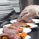 Plates of meat being prepared.