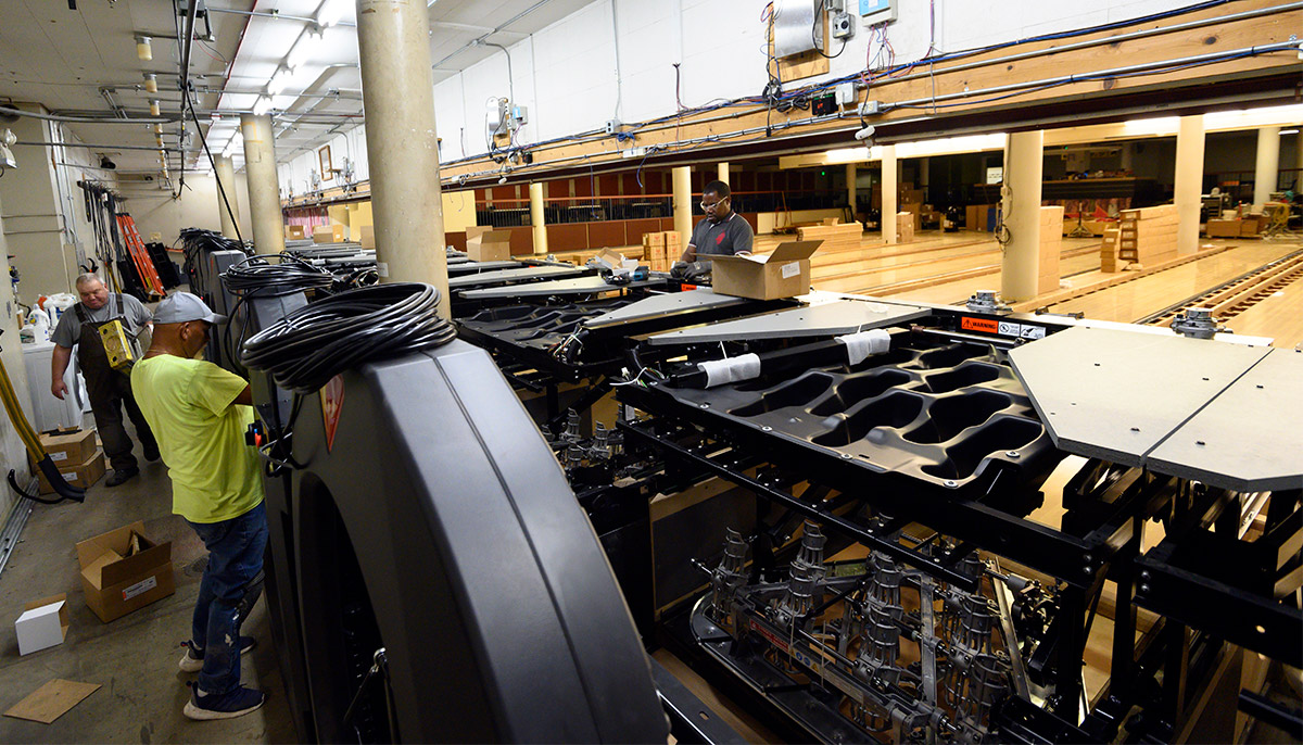 Workers install new pinsetter machines in the UC Davis bowling lanes.