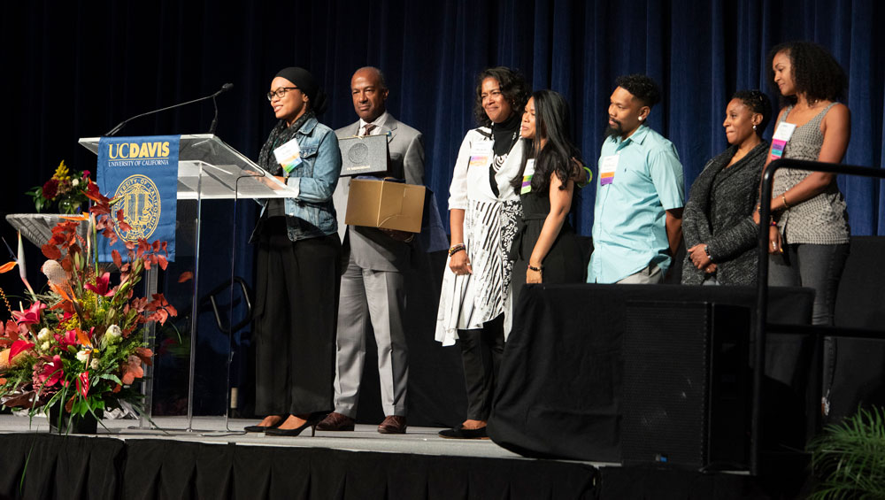 Members of Walter A. Robinson's family, on stage, with Chancellor Gary S. May.