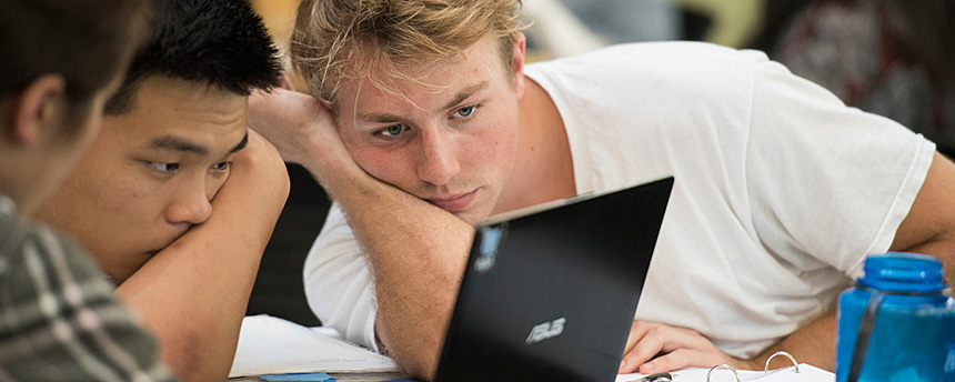 Students look at a laptop screen