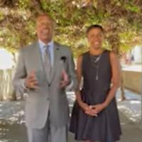 Chancellor Gary May and LeShelle standing under some vines 