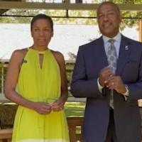 Chancellor Gary May and LeShelle in front of a bench