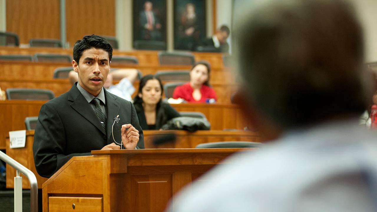 Miguel Zavala, participant in the King Hall Outreach Program, argues before a panel of judges in a mock courtroom
