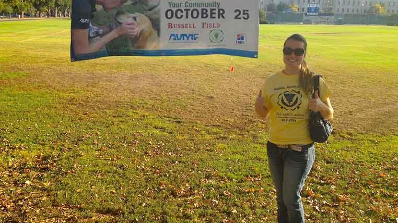 Photo: Tereza Chylkova shows off promotional banner for the Animal Adoptathon, on Russell Field.