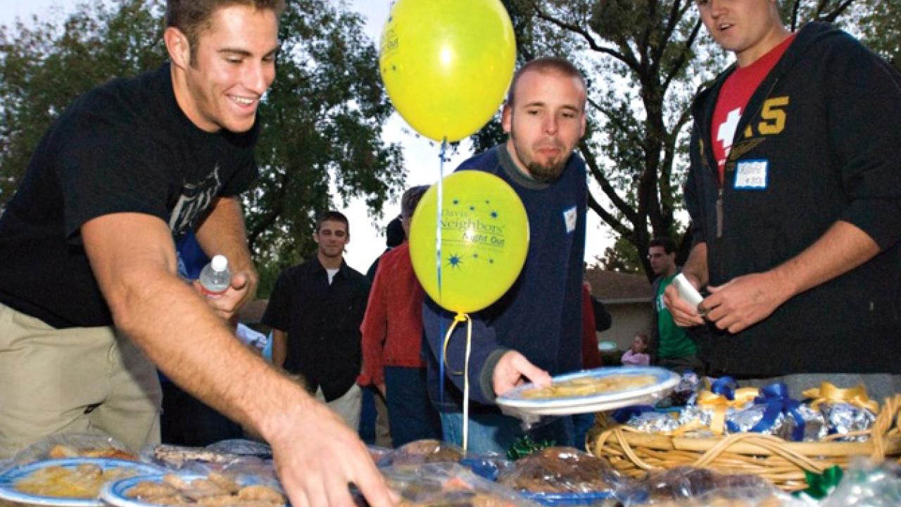 Photo: Block party scene (people at food table)