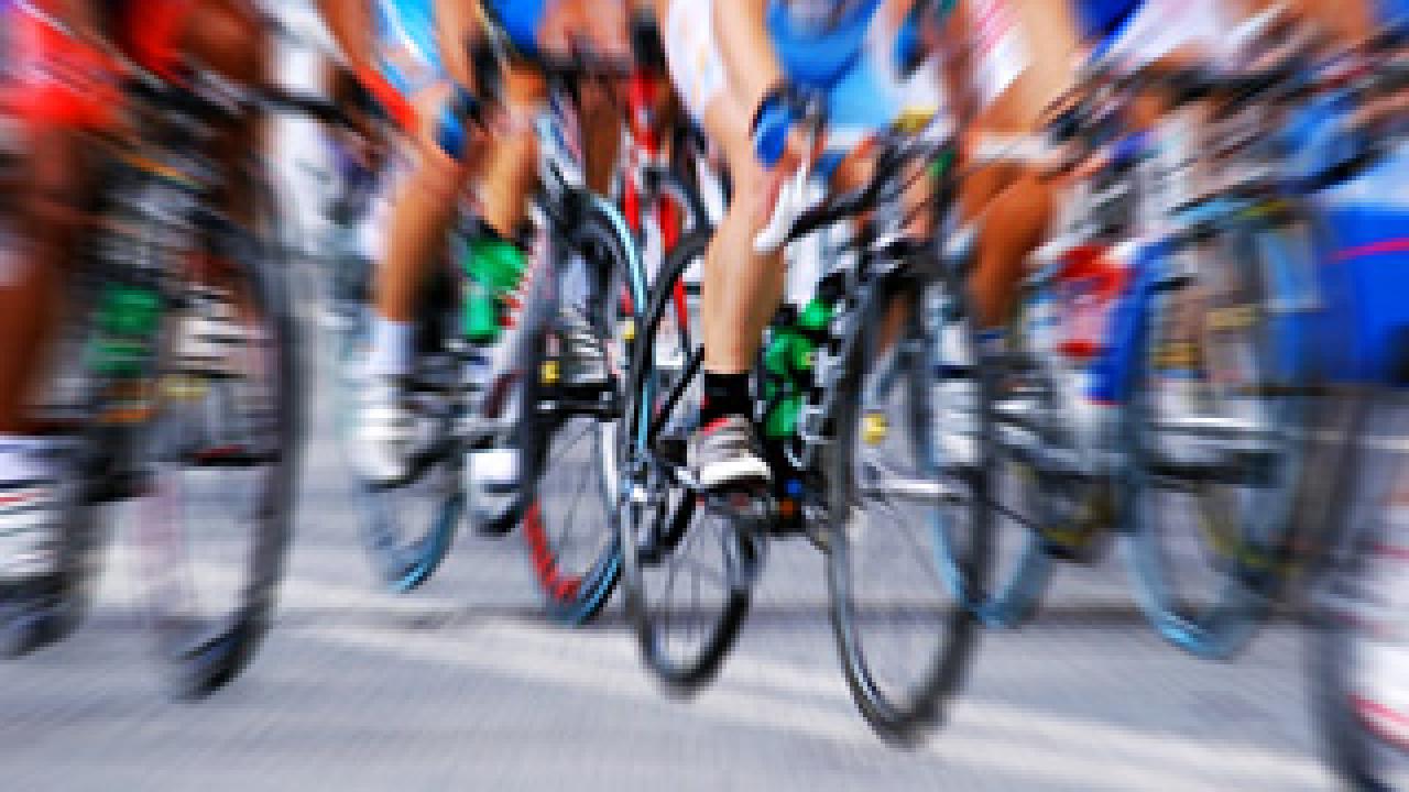 Photo of professional cyclists in a pack close up