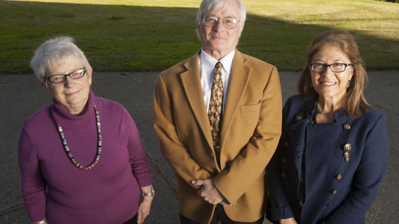 Photo: Faculty members, posing outside, in a line