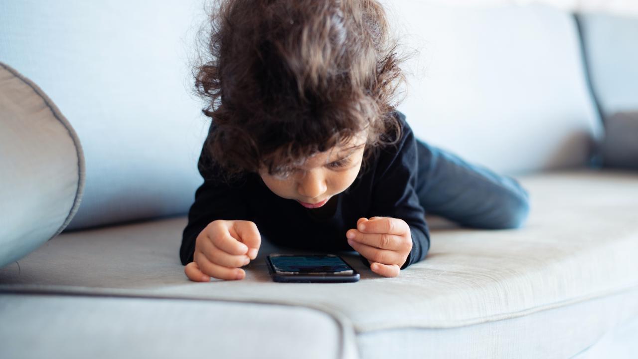 Toddler with phone.