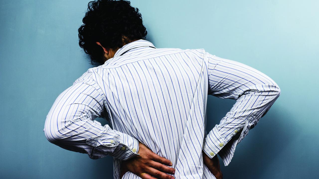 woman clutching back in pain