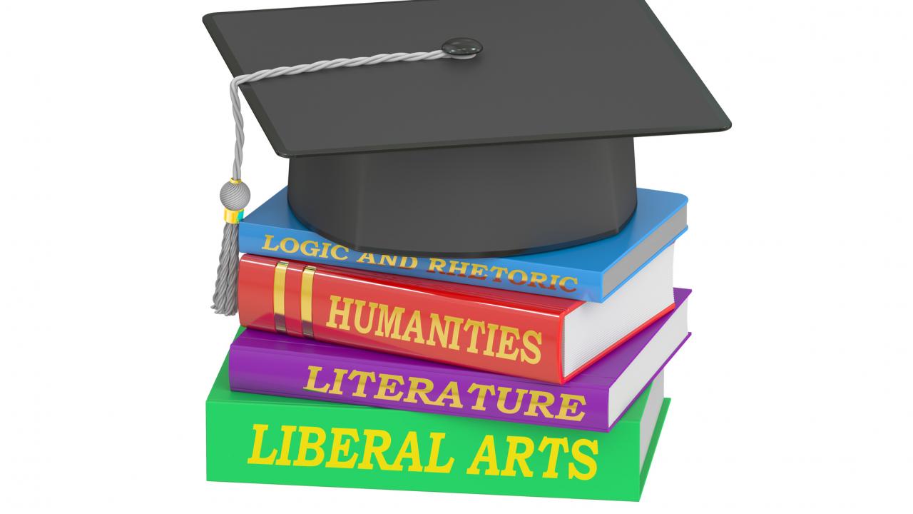 Books stacked with grad cap,