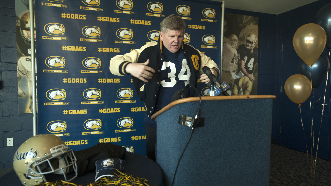 Dan Hawkins puts on his UC Davis letterman jacket.