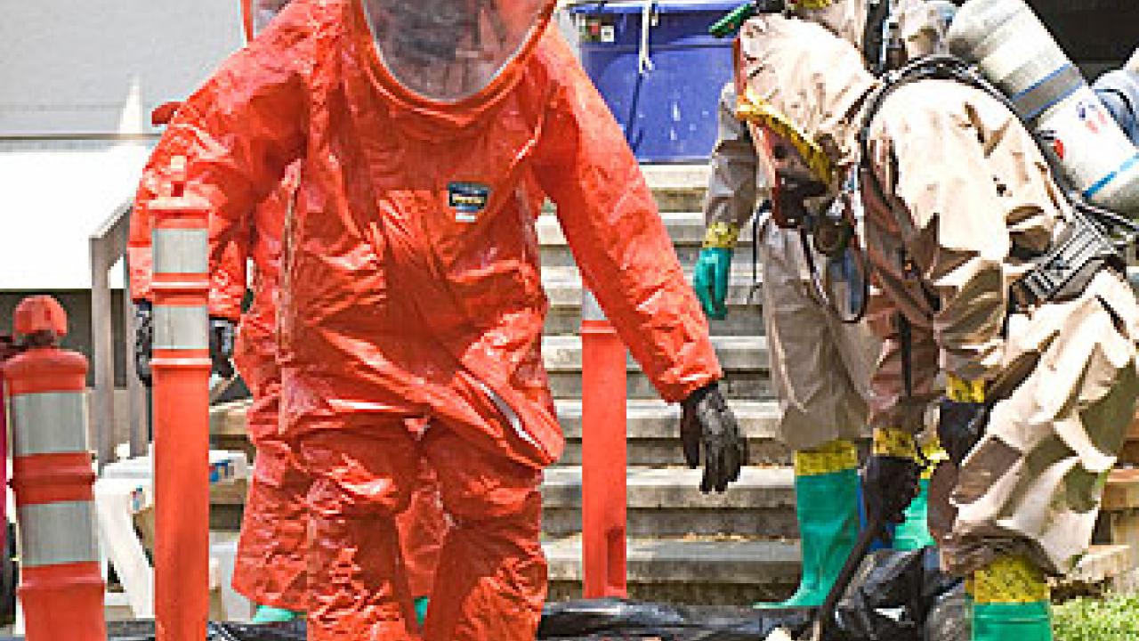 UC Davis firefighters Dave Dean and Scott Meyer in protective suits to guard against exposure to hazardous materials.