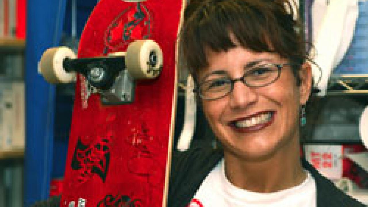 Lisa Girsh shows off the skateboard autographed by NASCAR driver Dale Earnhardt Jr., after he was hospitalized briefly last month at the medical center.  