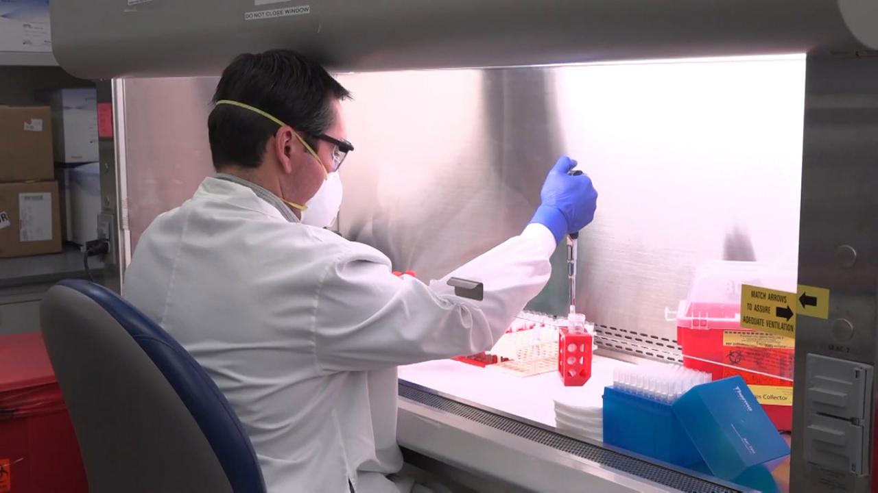 Researcher with vials of samples.