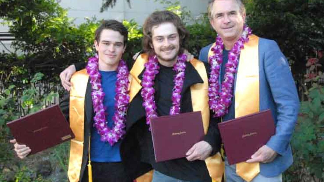 Photo: Julian and Sebastian Fletcher-Taylor and their dad, J. Edward Taylor, posing with diplomas in hand.