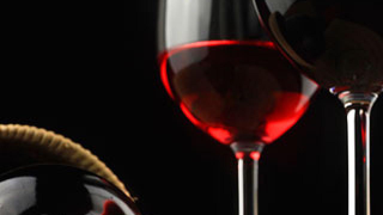 bottle on its side and wine in glasses