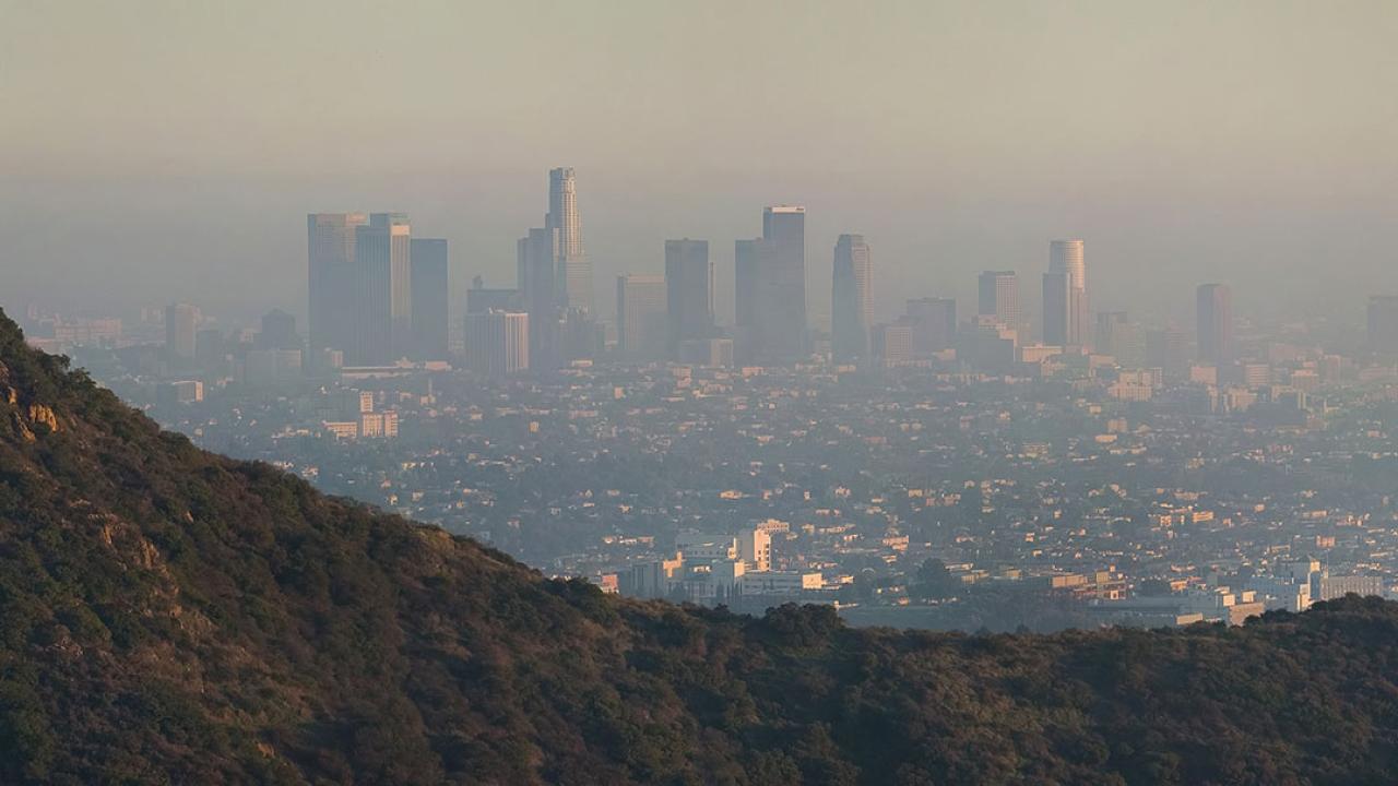 Los_Angeles_Pollution Photo of a city downtown, seen from a distance, shrouded in smog.