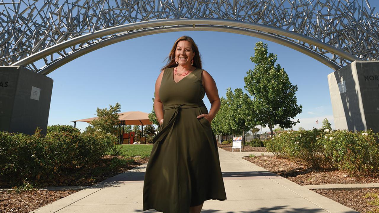 A woman stands under an arch