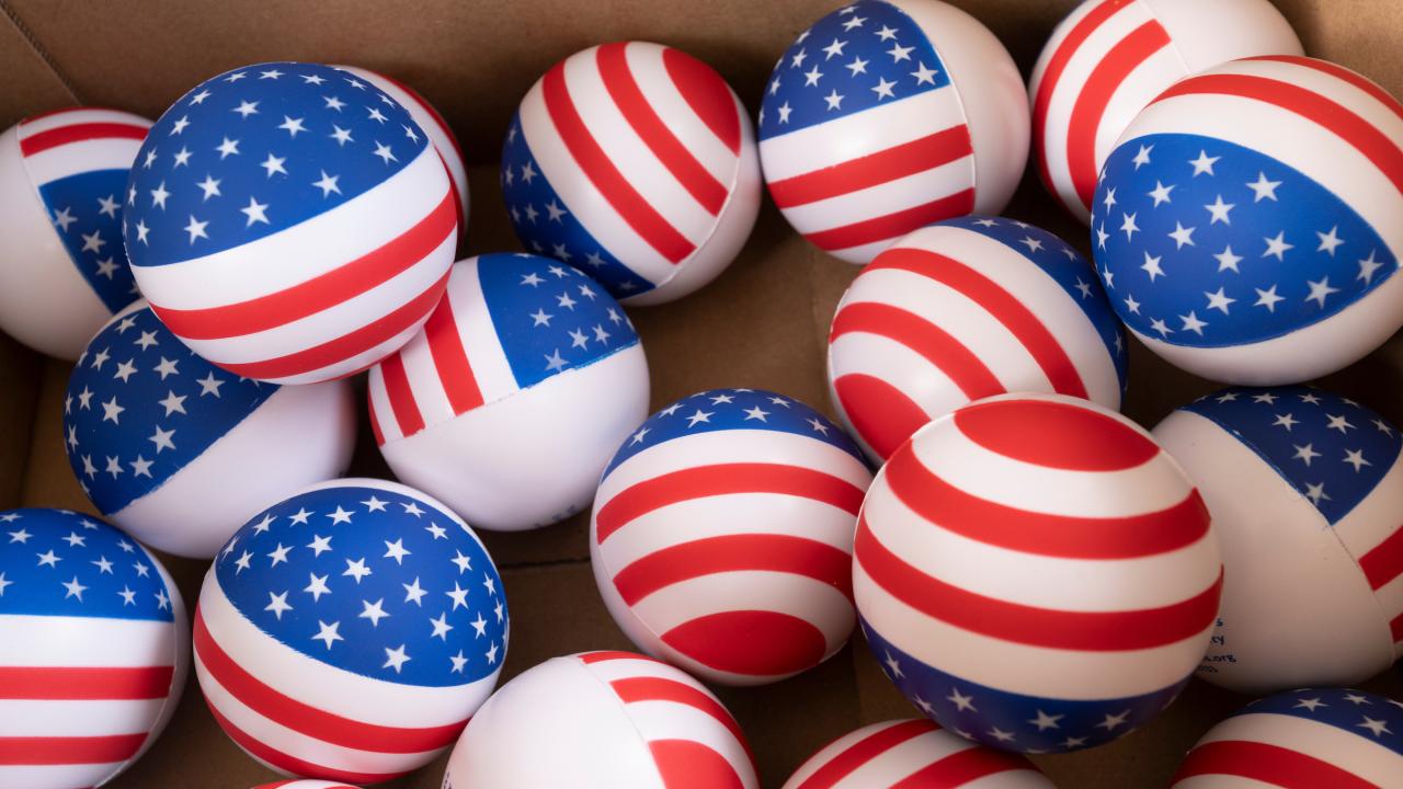 Box of red, white and blue balls patterned with U.S. flags (photograph)