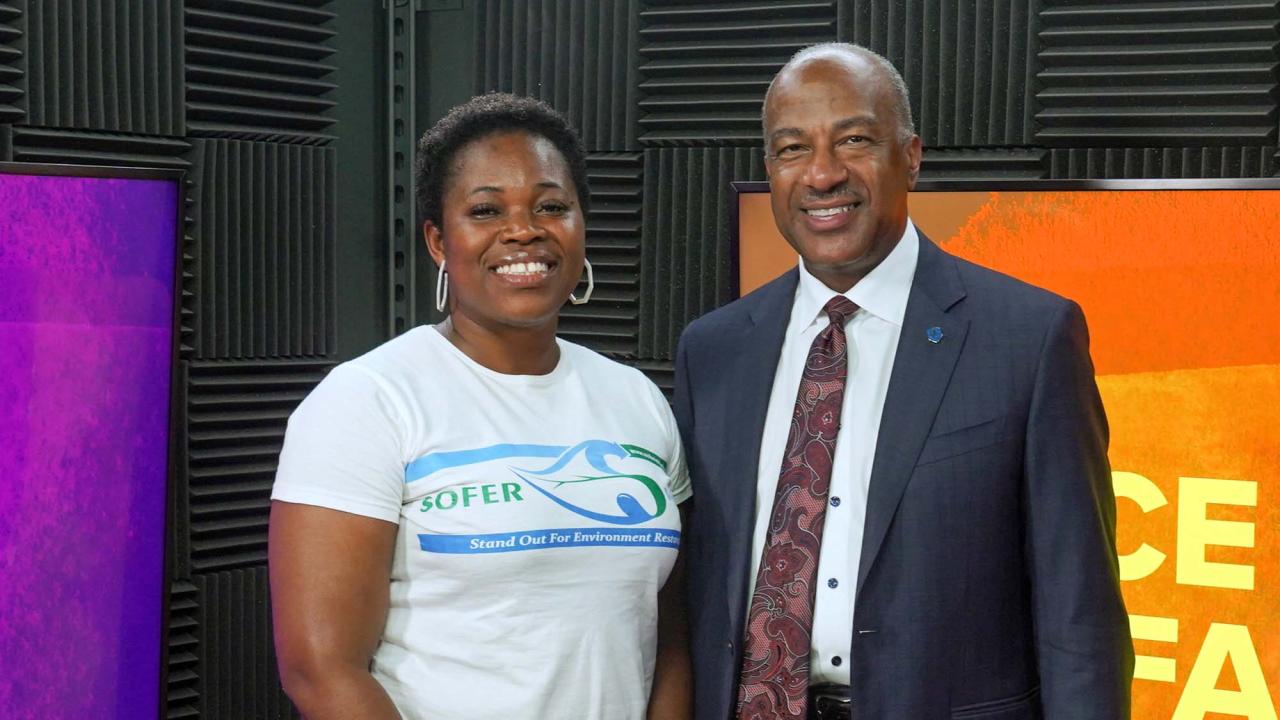 Uyi Effiom and Chancellor Gary S. May pose for a photo in the video studio for Face to Face With Chancellor May.