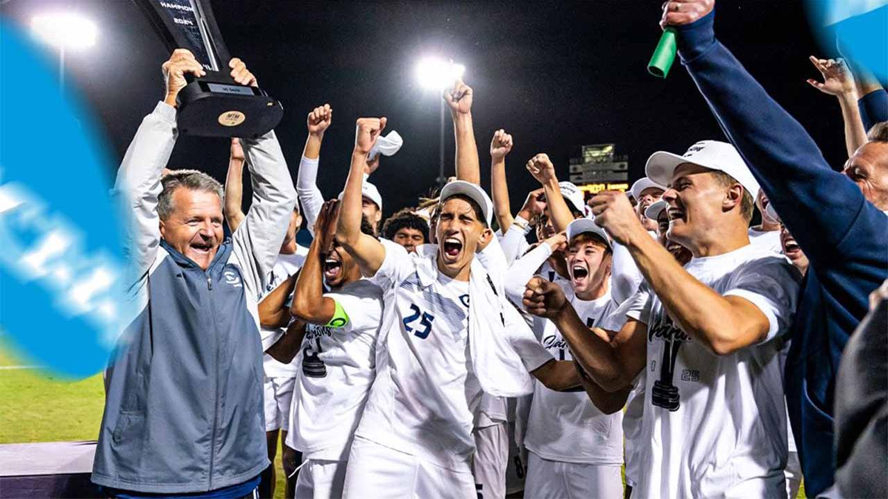 soccer players and coahces cheer and hold a trophy