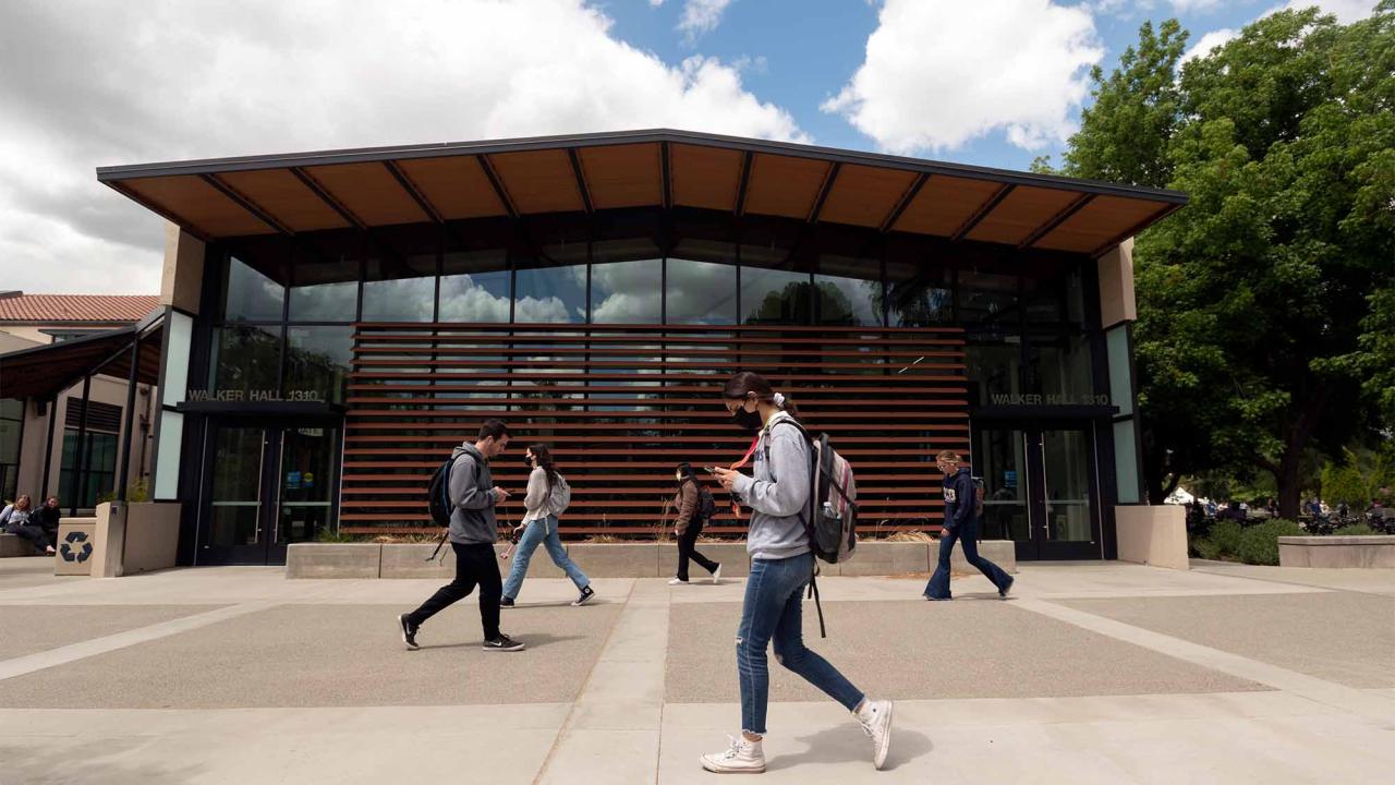 Students walk past Walker Hall