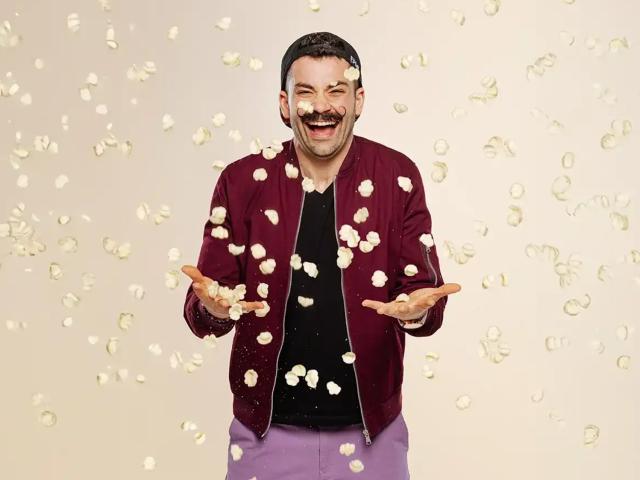 Joe Sasto throws puff chips in the air and laughs