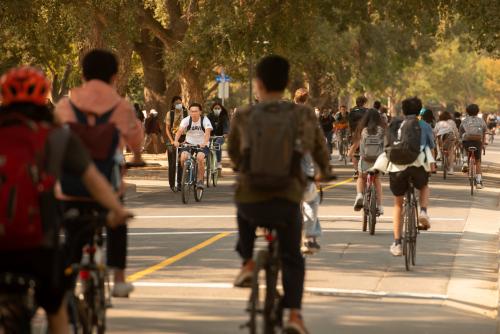 Students Biking on Campus During A Sunny Day