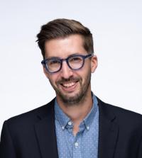 Portrait of a bearded man with glasses and brown hair