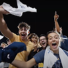 Students cheering at an athletics event during Aggie Orientation