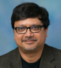 portrait of man with dark hair and glasses