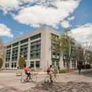 Students bicycle near Shields Library.