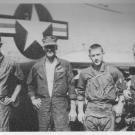 Black-and-white image of four GIs on airfield, during Vietnam War