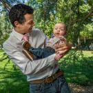 A student holds his baby.