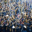 Blue and gold streamers falling on graduates.