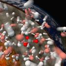 Model of various colored molecules as they dissolve with a cross section of the Earth behind