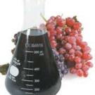 photo: flask of wine with grapes in background