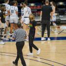 Coach "chats" with referee on court.