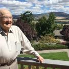 John D. Kemper on balcony, scenery behind