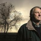 John Harris stands in front of a tree.