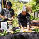 Chef places food on table.