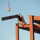 Steelworkers assemble the steel I-beams on a building