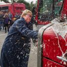 Lola Hogan breaks a bottle of beer on a Unitrans bus