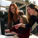 Students look at a computer.